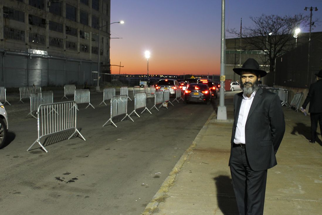 Mayer Kotlarsky awaits a friend's arrival outside the International Conference of Chabad-Lubavitch Emissaries banquet at the South Brooklyn Marine Terminal on Sunday night. <br/>(Nathan Tempey/Gothamist)